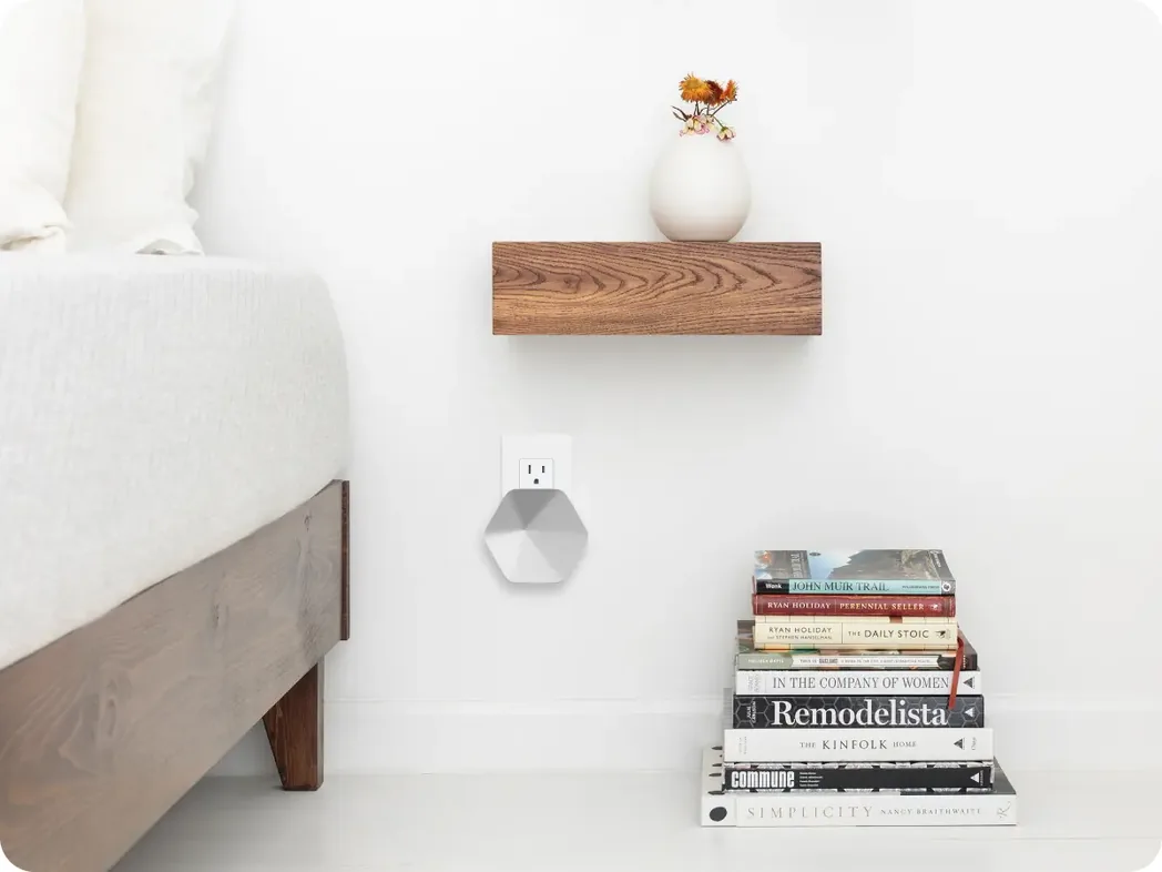 A SuperPod plugged in beside a bedside table